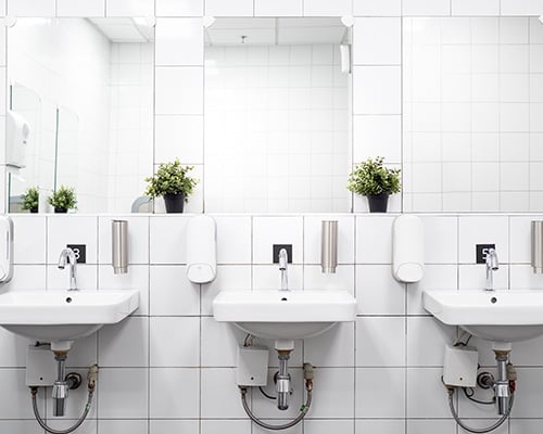 Commercial restroom with a row of sinks