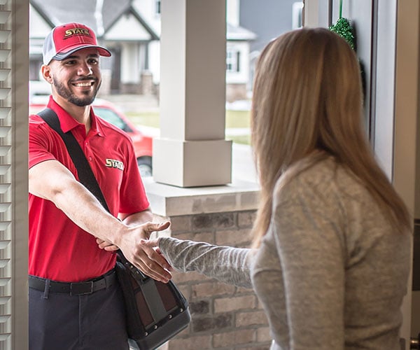 Stack technician greeting a homeowner at the door