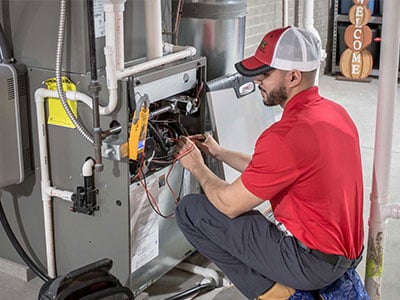 Stack technician servicing a furnace